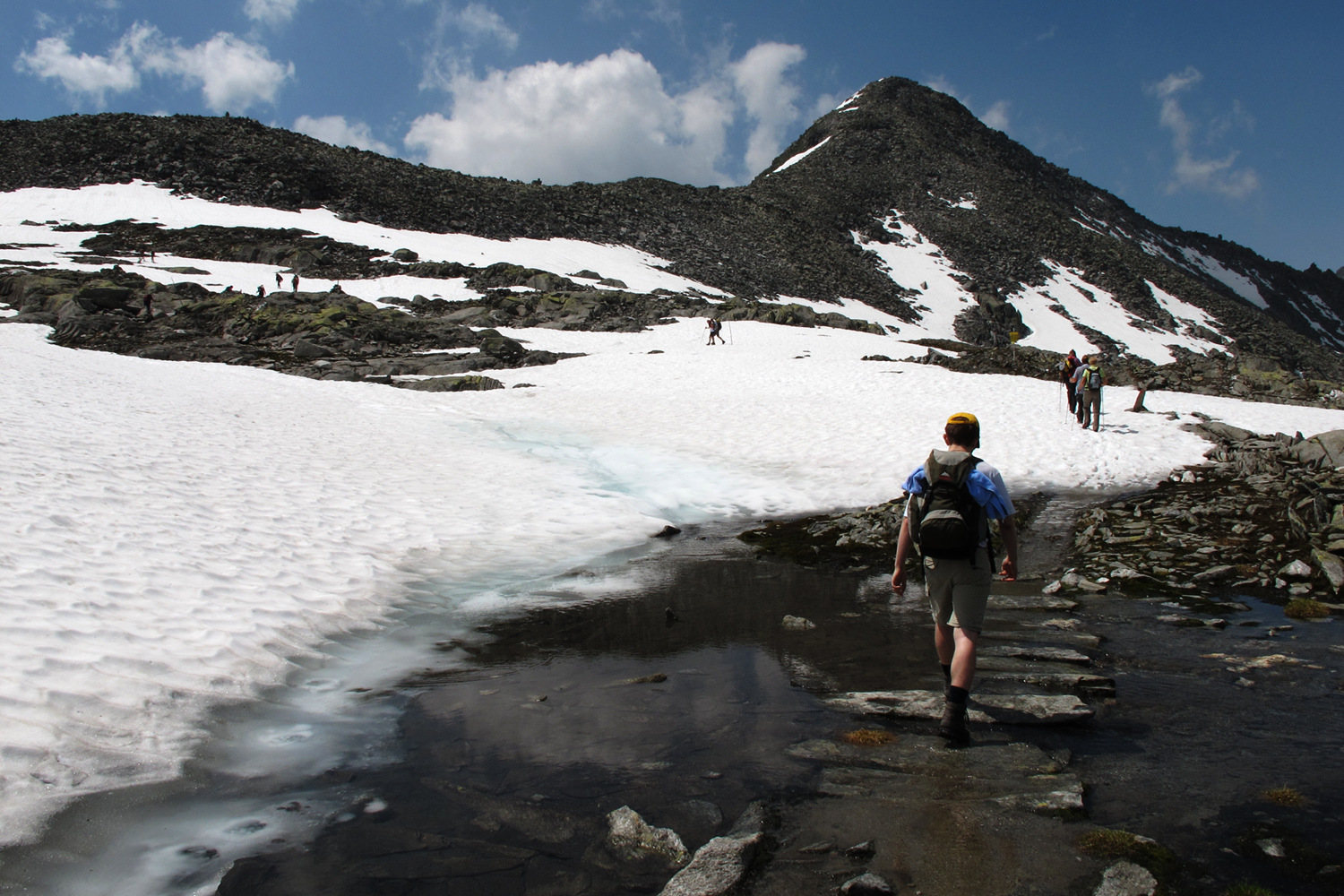 Hiking over snow and water in high alpine regions.